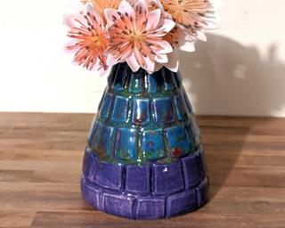 Adorn your home with this one of a kind little carved vase with colors reminiscent of a Monet painting.