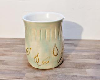 Adorn your home with this one of a kind vase designed with abstract yellow leaves.