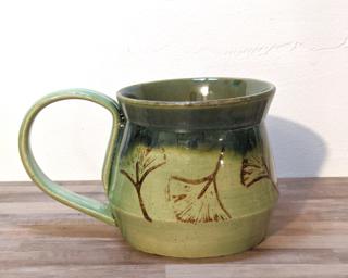 A lovely ceramic mug with gorgeous green glazes inside and out and stamped with ginkgo leaves.