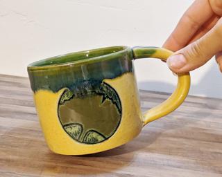 A hefty ceramic mug with a gorgeous ginkgo leaf carved on either side.