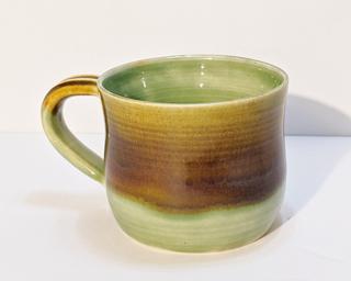 A nice Earthy-toned glazed ceramic mug, perfect for a morning cup of coffee.