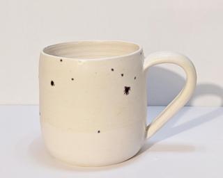A nice speckled ceramic mug, perfect for a morning cup of coffee.