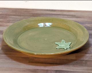 A lovely green dinner plate for your table.