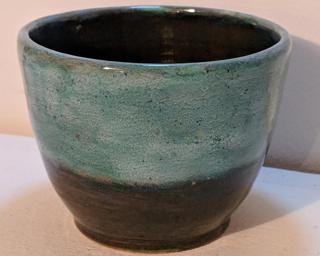 Adorn your home with this one of a kind speckled green and red-brown toned planter.