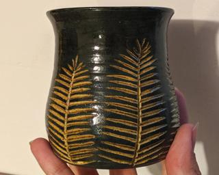 Adorn your home with this one of a kind vase which sports multiple carved pine tree-like branches.