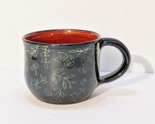 A carefully carved ceramic mug, perfect for a morning cup of coffee.