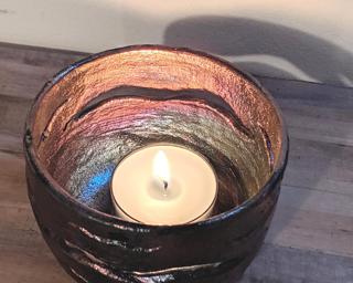 A lovely wavy metallic candle holder for your table.