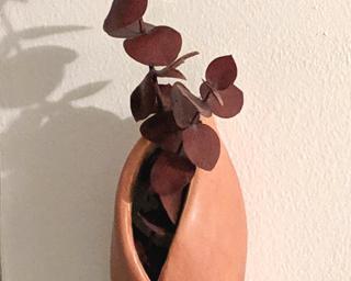 A sweet little vase or planter for your wall.