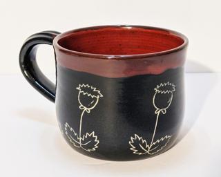 A carefully carved ceramic mug, perfect for a morning cup of coffee.