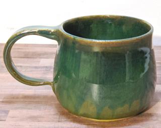 A hefty ceramic mug with a gorgeous sea green and blue drip around the outside.