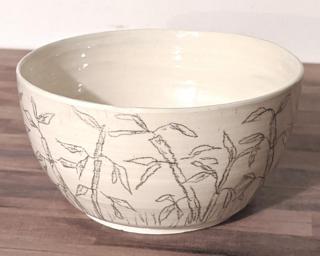 Adorn your home with this unique planter decorated with bamboo sketches around the outside.