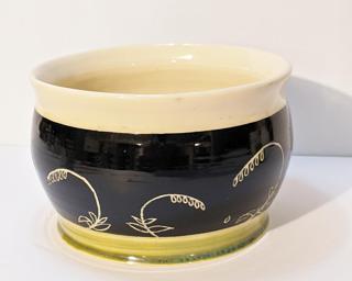 Adorn your home with this lovely sgraffito planter with lovely green and black glazes.