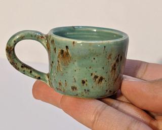 A sweet little blue and brown speckled mug, perfect for holding a little succulent, or a great addition to one's doll house accessories' collection.