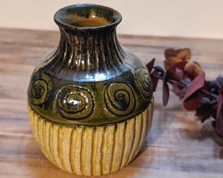 Adorn your home with this one of a kind little carved vase.
