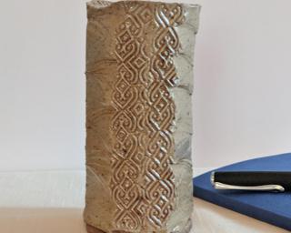 A lovely and unique vase for your shelf.
