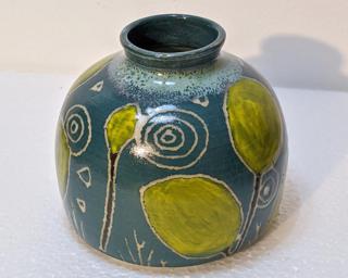 Adorn your home with this one of a kind vase designed with abstract yellow leaves.