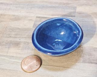 A sweet little blue bowl, perfect for holding rings, or a great addition to one's doll house accessories' collection.