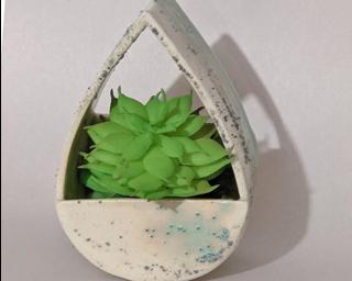 A sweet little vase or planter for your wall.