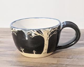 A carefully carved ceramic mug, perfect for a morning latte.