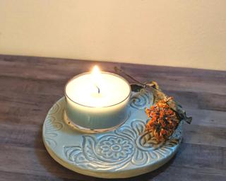 A lovely light green candle dish for your table.