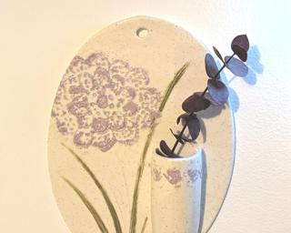 A sweet little vase or planter for your wall.