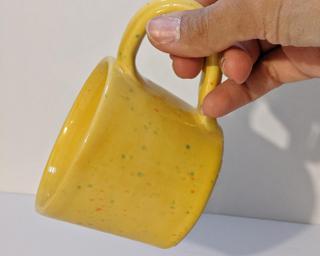 A lovely ceramic mug with unique blend of drippy glazes around the outside.