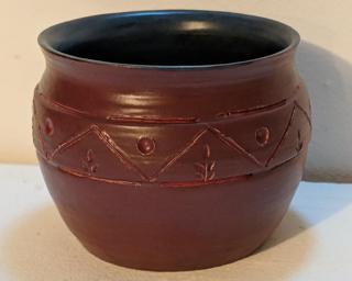 Adorn your home with this one of a kind tribal-inspired carved planter.