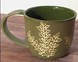 A carefully carved ceramic mug, perfect for a morning latte.