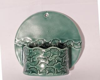A sweet little planter for your wall. Small crack at the top