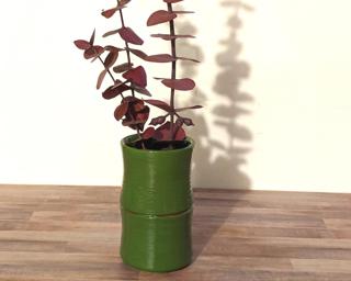 Adorn your home with this one of a kind vase which sports multiple carved leaves around an glossy gold vessel.
