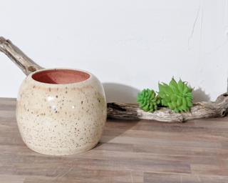 Adorn your home with this cream and pink speckled vase.