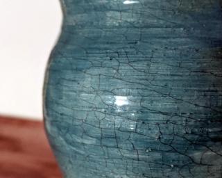 Adorn your home with this bold turquoise planter with a unique crackle design.