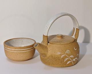A one of a kind little ceramic teapot that is sure to brighten up your next tea party.