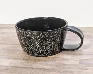 A carefully carved ceramic mug, perfect for a morning latte.