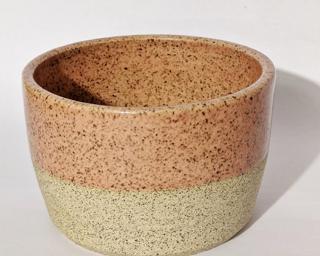 A soft pink and white speckled planter to dress up your shelf.
