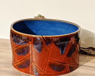A nice hefty planter for your shelf. Cosmetic crack at bottom