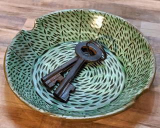 A sweet little carved dish for your dresser.