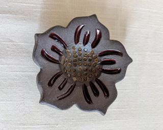 This sweet little dish is made from mid fire brown clay with subtle red and yellow glazes that beautifully accentuate the carved lines.