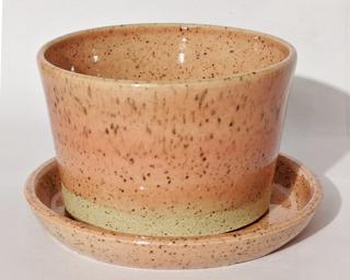 A soft pink and white speckled planter and matching dish to dress up your shelf.