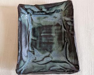 This sweet little dish is made from mid fire brown clay with a grayish-blue glaze over the top.