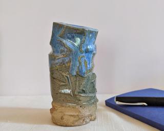 A lovely and unique vase for your shelf.