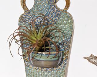 A unique planter for your wall. Does not lay flat