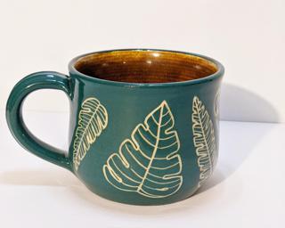 A carefully carved ceramic mug, perfect for a morning cup of coffee.